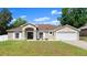 Charming single-story home with stone accents, inviting front porch, and well-manicured lawn at 2600 Scottville Ave, Deltona, FL 32725