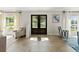 Inviting foyer with large windows, tile floors, and elegant double doors at 2600 Scottville Ave, Deltona, FL 32725
