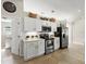 Well-lit kitchen with stainless steel appliances, white cabinets, and decorative accents at 2600 Scottville Ave, Deltona, FL 32725