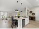 Kitchen island featuring barstool seating, stainless steel appliances, and modern lighting at 2600 Scottville Ave, Deltona, FL 32725