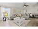 Bright and airy living room featuring a plush sofa, decorative wall art, and natural light at 2600 Scottville Ave, Deltona, FL 32725