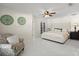 Spacious main bedroom with white tile flooring, statement chair, ceiling fan, and direct access to exterior through French doors at 2600 Scottville Ave, Deltona, FL 32725