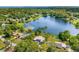 Picturesque aerial view of lakefront homes nestled amidst lush greenery and a serene lake backdrop at 10 Madera Rd, Debary, FL 32713