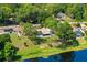 Lake view aerial shot of homes surrounded by mature trees and lush greenery at 10 Madera Rd, Debary, FL 32713