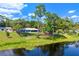 Aerial view of lakefront property with fire pit and dock at 10 Madera Rd, Debary, FL 32713