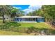 Charming home with a screened porch, lush yard, and black fence at 10 Madera Rd, Debary, FL 32713