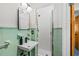 Cozy bathroom with green tiling, sleek fixtures, and a shower at 10 Madera Rd, Debary, FL 32713