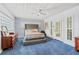Cozy bedroom with textured wallpaper, plush blue carpet, and ample natural light at 10 Madera Rd, Debary, FL 32713