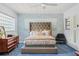 Charming bedroom features soft blue walls, textured wallpaper and large bed with decorative pillows at 10 Madera Rd, Debary, FL 32713