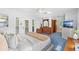 Comfortable bedroom with light blue walls, textured bedding and view into hallway and bathroom at 10 Madera Rd, Debary, FL 32713