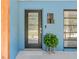 Stylish front door with modern hardware, greenery, and a sleek design at 10 Madera Rd, Debary, FL 32713