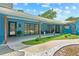 Inviting front porch with modern furniture, stylish lighting, and vibrant landscaping at 10 Madera Rd, Debary, FL 32713