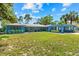 Charming blue single-story home with a manicured lawn and covered carport at 10 Madera Rd, Debary, FL 32713