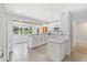 Bright kitchen featuring white cabinets, countertops, and a scenic lake view from the window at 10 Madera Rd, Debary, FL 32713