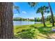 Picturesque lake view framed by lush greenery and clear blue skies, ideal for relaxation at 10 Madera Rd, Debary, FL 32713