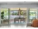 Beautiful lanai with dining table and stunning lake views visible through sliding glass doors at 10 Madera Rd, Debary, FL 32713