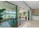 Inviting sunroom boasting a dining table and relaxing views of the tranquil lake at 10 Madera Rd, Debary, FL 32713