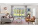 Cozy living room with a large window overlooking the yard and stylish furniture at 10 Madera Rd, Debary, FL 32713