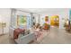 Bright living room featuring modern decor, comfortable seating, and a large window offering views of the front yard at 10 Madera Rd, Debary, FL 32713