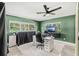 Chic office features green walls, modern desk with computer and natural light at 10 Madera Rd, Debary, FL 32713