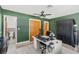 Stylish home office with green walls, computer and black curtains at 10 Madera Rd, Debary, FL 32713