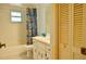 Bathroom features a bathtub with shower, commode, single sink vanity and storage at 1010 Hanford Dr, Deltona, FL 32738