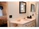 Bathroom with single sink vanity, decorative mirror and coastal decor at 1010 Hanford Dr, Deltona, FL 32738