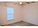 Bright bedroom featuring a window, ceiling fan, and neutral carpet at 1010 Hanford Dr, Deltona, FL 32738