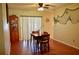 Cozy dining area featuring wood floors, a ceiling fan, and a glass door to the outside at 1010 Hanford Dr, Deltona, FL 32738