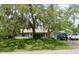 Charming single-story home with mature trees and a well-manicured lawn at 1010 Hanford Dr, Deltona, FL 32738