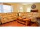 Cozy living room featuring a large sectional sofa and a wooden coffee table at 1010 Hanford Dr, Deltona, FL 32738