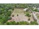 Aerial perspective of the estate showing vineyard rows, lush trees, and expansive land, offering a sense of scale and beauty at 1056 Reynolds Rd, De Leon Springs, FL 32130