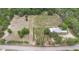 Aerial view of the property featuring vineyard rows, main house, and surrounding greenery, highlighting its rural charm at 1056 Reynolds Rd, De Leon Springs, FL 32130