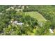 Vast property features rows of crops surrounded by green trees, with residential buildings tucked into the landscape at 1056 Reynolds Rd, De Leon Springs, FL 32130