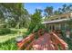 Backyard showcasing a wooden deck and a lush green lawn at 1056 Reynolds Rd, De Leon Springs, FL 32130