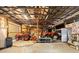 Wide shot of barn's interior with high ceiling, two orange tractors, and garage door for equipment storage at 1056 Reynolds Rd, De Leon Springs, FL 32130