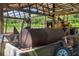 Barn interior with a fuel tank and a tractor, showcasing storage at 1056 Reynolds Rd, De Leon Springs, FL 32130