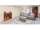 Cozy basement living area with comfortable seating, shelving, and stairs at 1056 Reynolds Rd, De Leon Springs, FL 32130