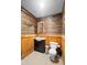 Bathroom with wood paneled walls, sink, toilet, mirror and lighting at 1056 Reynolds Rd, De Leon Springs, FL 32130