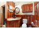 Bathroom features wood paneled walls and sink vanity with decorative elements at 1056 Reynolds Rd, De Leon Springs, FL 32130