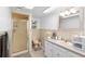 Cozy bathroom featuring a walk-in shower, neutral color palette, and ample storage at 1056 Reynolds Rd, De Leon Springs, FL 32130