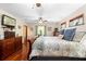 Comfortable bedroom with wood floors, large windows, ceiling fan, and cozy décor at 1056 Reynolds Rd, De Leon Springs, FL 32130