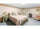 Comfortable bedroom with floral accents, complemented by a side table, soft lighting, and a cozy sitting chair at 1056 Reynolds Rd, De Leon Springs, FL 32130
