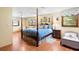 Bright and inviting bedroom with hardwood floors, ceiling fan, and large windows with views to the exterior at 1056 Reynolds Rd, De Leon Springs, FL 32130