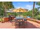 Outdoor kitchen, umbrella table, and seating provide an ideal space for entertaining near the pool at 1056 Reynolds Rd, De Leon Springs, FL 32130