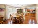 A bright dining room features hardwood floors, chandelier and large windows that provide great view and natural light at 1056 Reynolds Rd, De Leon Springs, FL 32130