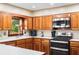 Well-equipped kitchen featuring hardwood cabinets, white countertops, and stainless steel appliances at 1056 Reynolds Rd, De Leon Springs, FL 32130