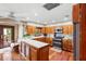 Inviting kitchen featuring stainless steel appliances, hardwood floors, and ample wood cabinetry, combining style and functionality at 1056 Reynolds Rd, De Leon Springs, FL 32130