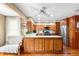 Eat-in kitchen with wood cabinets, white countertops, stainless steel appliances, and wood flooring at 1056 Reynolds Rd, De Leon Springs, FL 32130