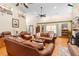 Spacious living room featuring vaulted ceilings, hardwood floors, and comfortable leather furniture at 1056 Reynolds Rd, De Leon Springs, FL 32130